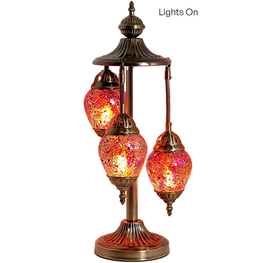 three lights on a stand with a white background