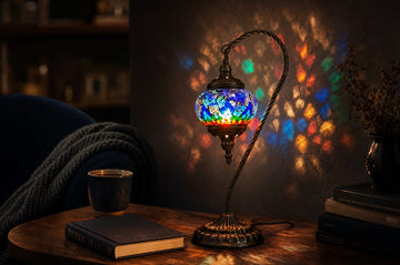A handmade Turkish-style mosaic glass lamp glowing in a cozy evening living room