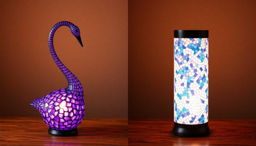 A purple swan-neck Turkish mosaic glass lamp beside a straight-necked cylindrical Turkish mosaic glass lamp on a wooden table