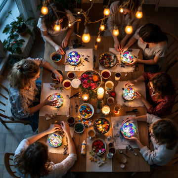 Friends gathered around a table hosting a Turkish mosaic lamp making party at home