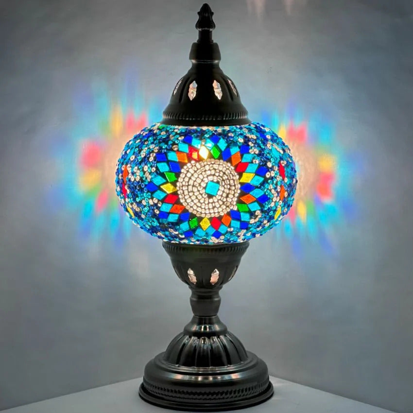 Cold Sunflower Turkish Lamp in Blue mosaic glass table lamp — glowing against a dark background