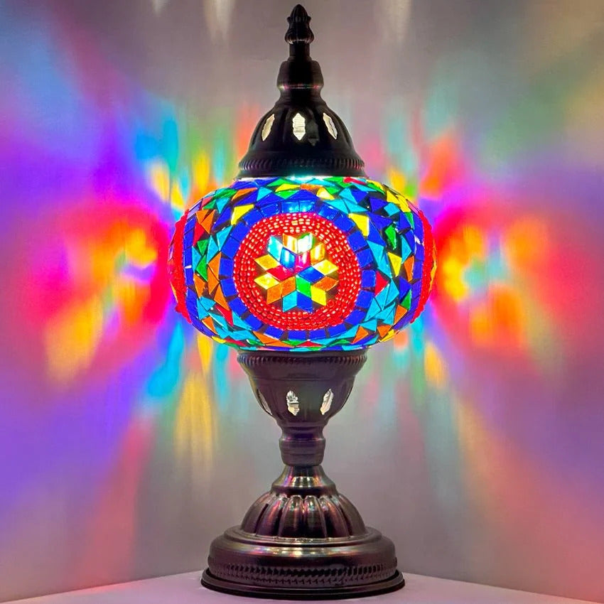 Desert Rose Blue Mosaic Desk Lamp mosaic glass table lamp — glowing against a dark background