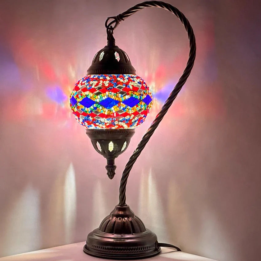 Turkish Lamp with Blue & Red Diamond Patterns mosaic glass table lamp — glowing against a dark background
