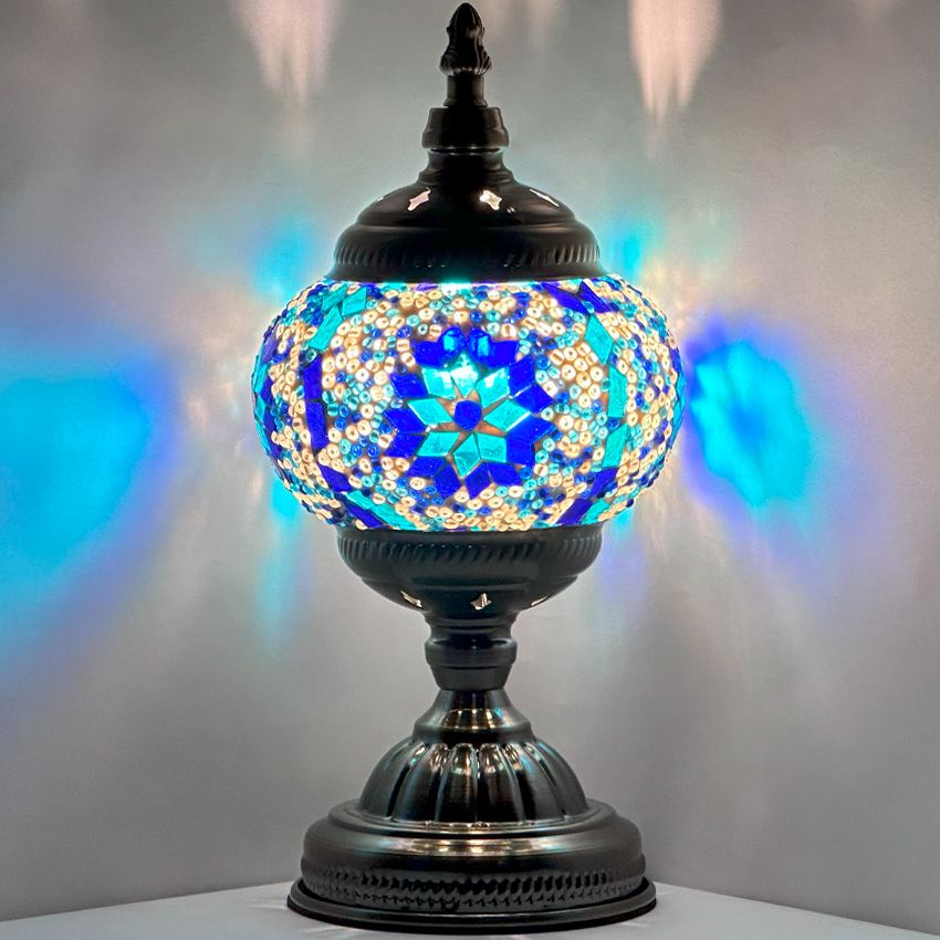 Moroccan mosaic glass table lamp — glowing against a dark background