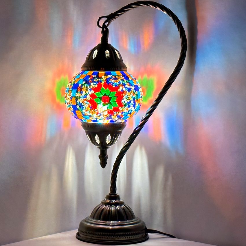 Floral Charm mosaic glass table lamp — glowing against a dark background