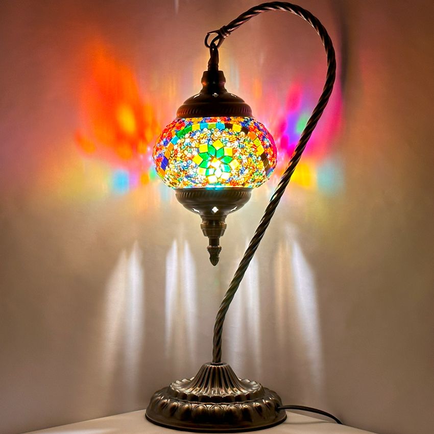 Goose Neck Mosaic Lamp with Colorful Flower Design mosaic glass table lamp — glowing against a dark background