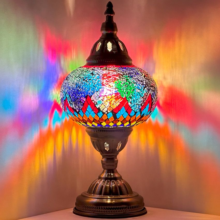 Cosmic Rainbow Bridge mosaic glass table lamp — glowing against a dark background