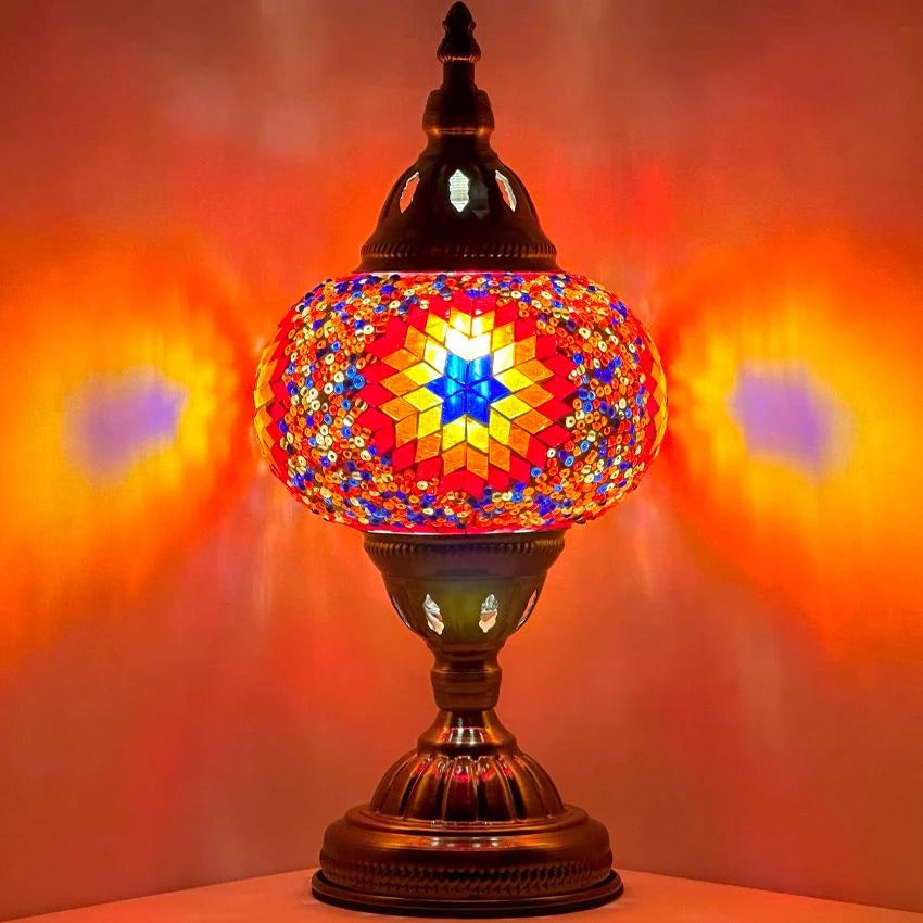 Desert Bloom Mosaic mosaic glass table lamp — glowing against a dark background