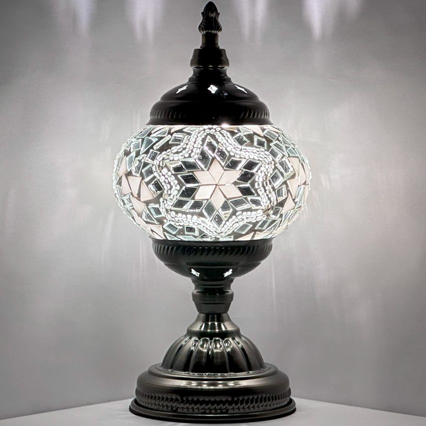 Moroccan Charm mosaic glass table lamp — glowing against a dark background