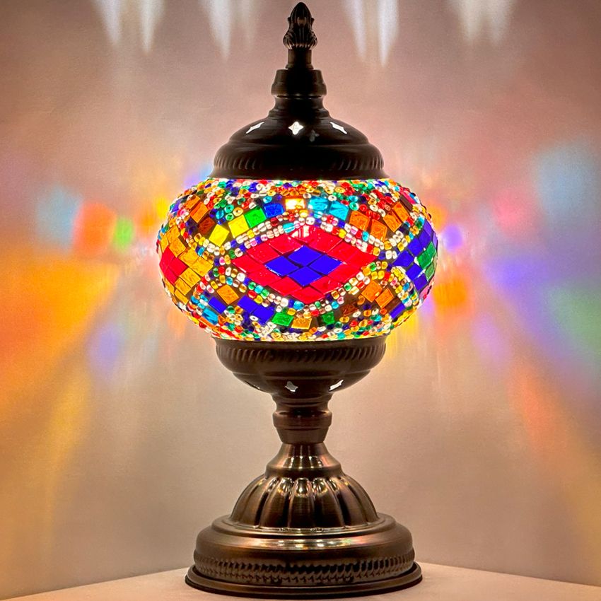 Rainbow Harmony mosaic glass table lamp — glowing against a dark background