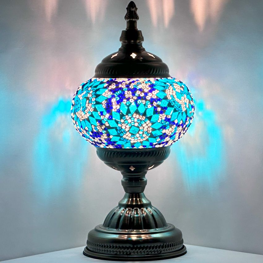 Blue Pearl Fantasy mosaic glass table lamp — glowing against a dark background