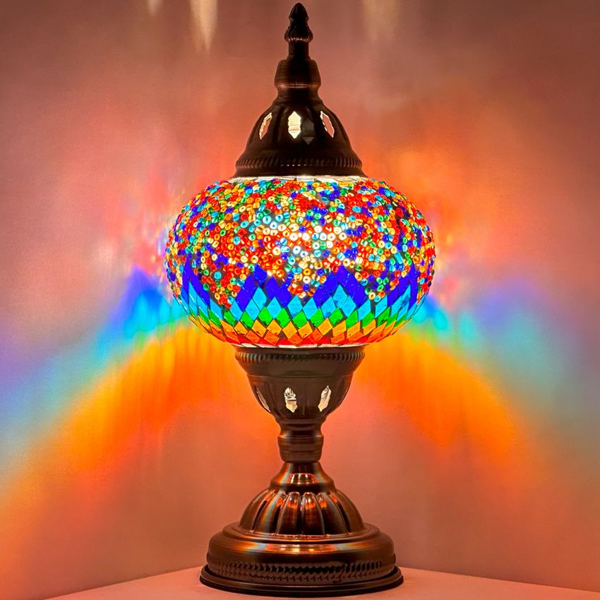 Spectrum Harmony mosaic glass table lamp — glowing against a dark background