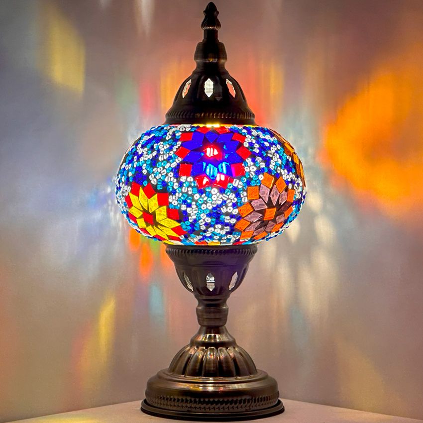 Tropical Elegance mosaic glass table lamp — glowing against a dark background