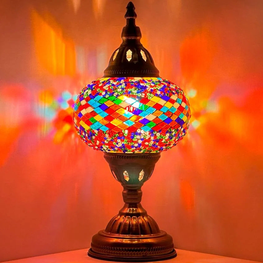 Color Spectrum mosaic glass table lamp — glowing against a dark background