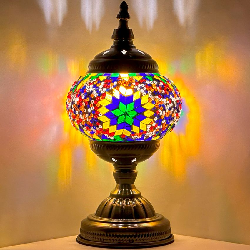 Sunset Aura mosaic glass table lamp — glowing against a dark background