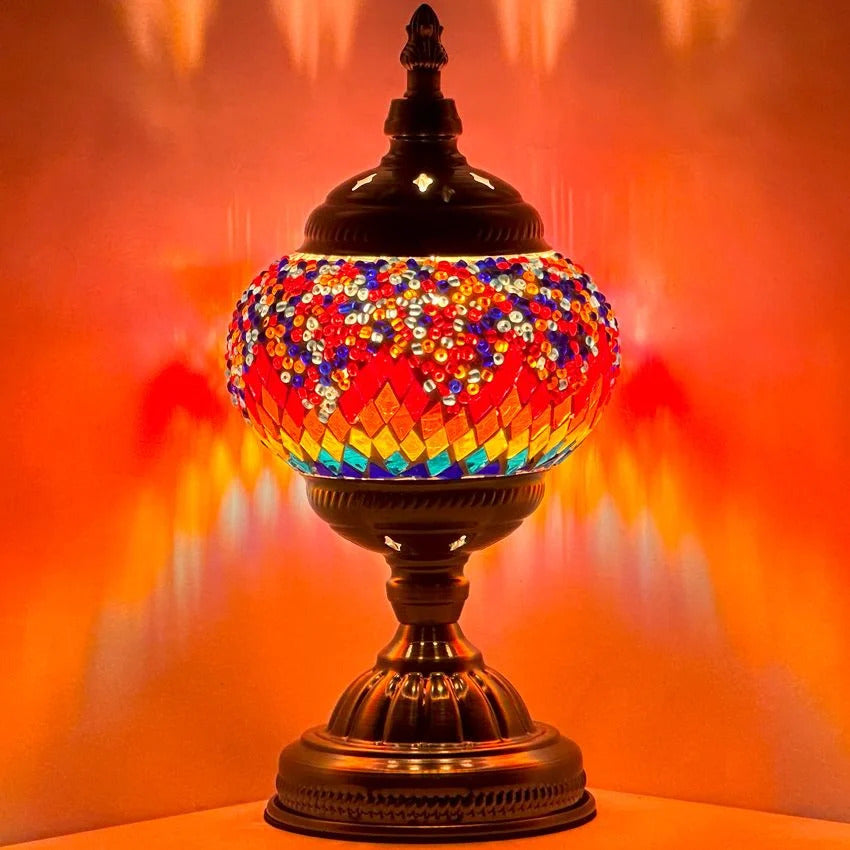 Crimson Spectrum mosaic glass table lamp — glowing against a dark background