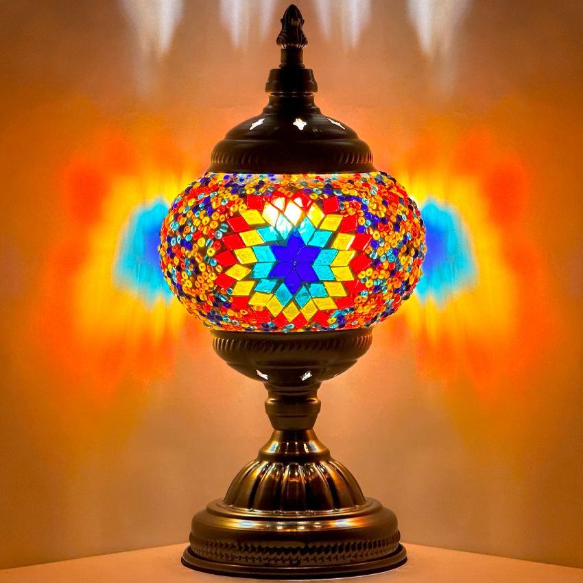 Kaleidoscope Dreams mosaic glass table lamp — glowing against a dark background