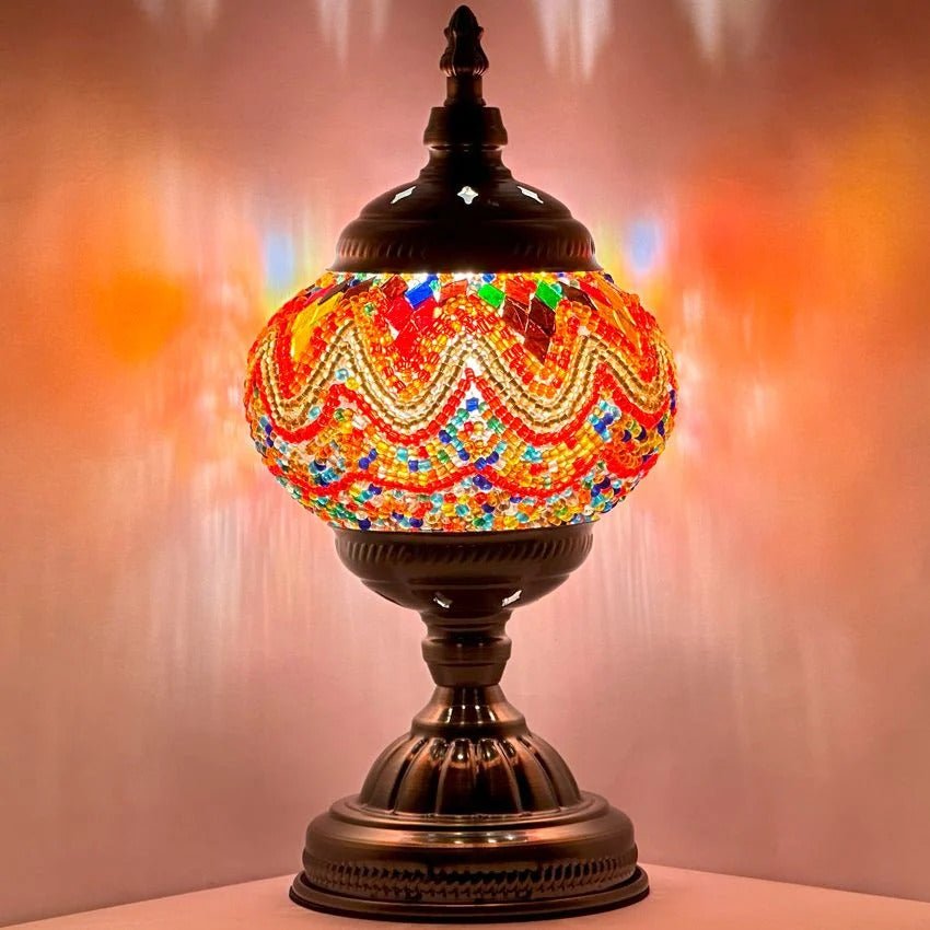 Fiery Echoes mosaic glass table lamp — glowing against a dark background