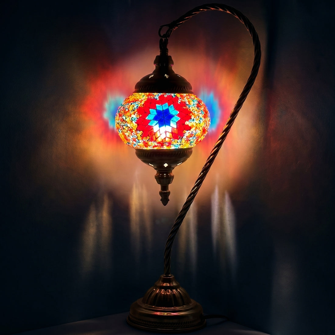 Blossoming Elegance mosaic glass table lamp — glowing against a deep charcoal background