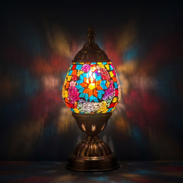 Blue Petal Mosaic Bedside Lamps mosaic glass table lamp — glowing against a deep charcoal background