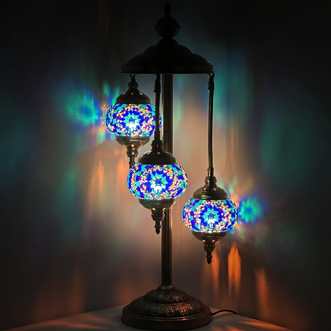 Blue Star Magic mosaic glass table lamp — glowing against a deep charcoal background