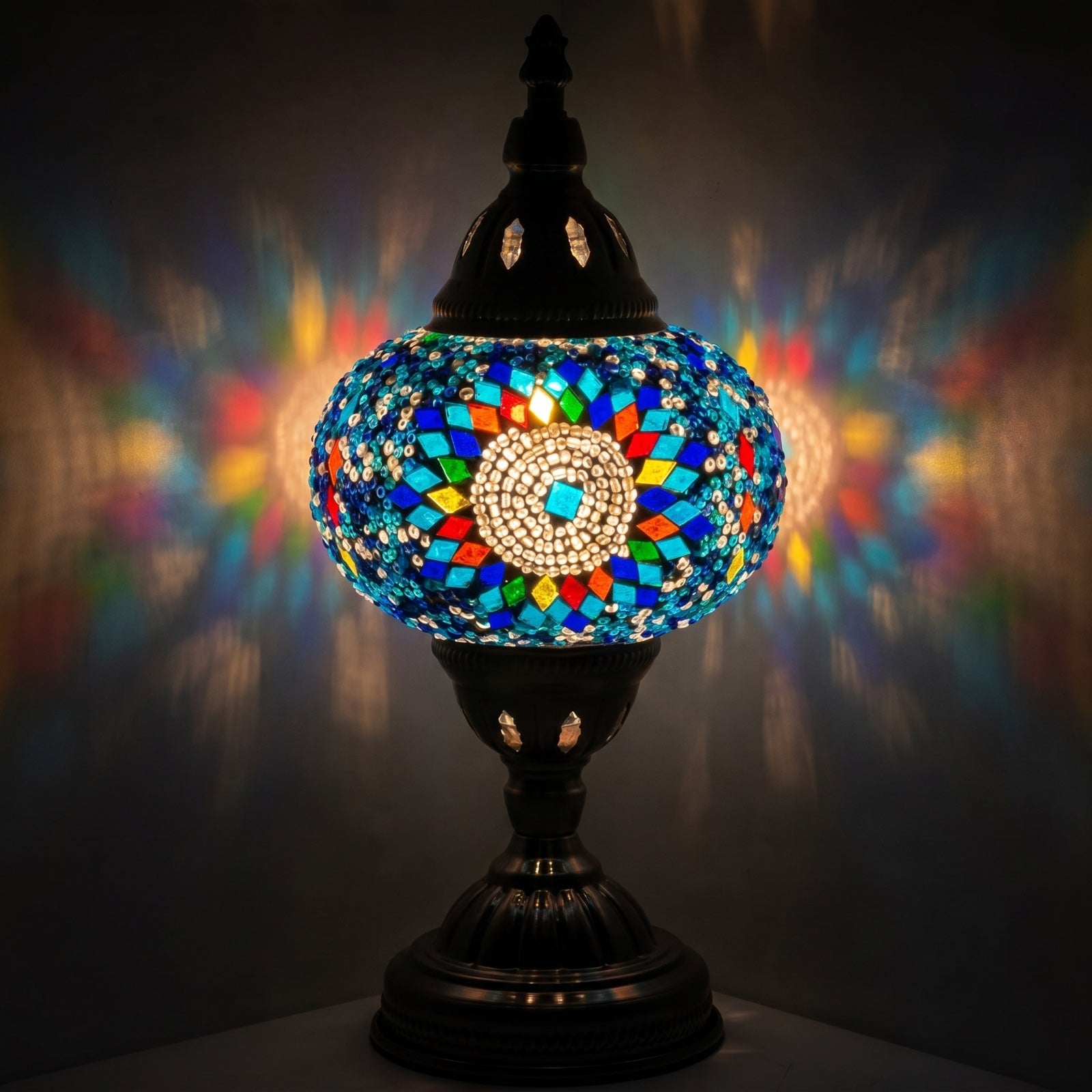 Cold Sunflower Turkish Lamp in Blue mosaic glass table lamp — glowing against a deep charcoal background