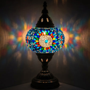 Cold Sunflower Turkish Lamp in Blue mosaic glass table lamp — glowing against a deep charcoal background