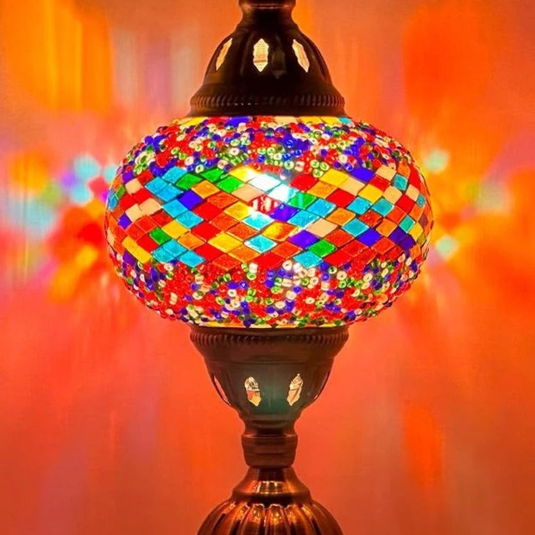 Color Spectrum mosaic glass table lamp — glowing against a deep charcoal background
