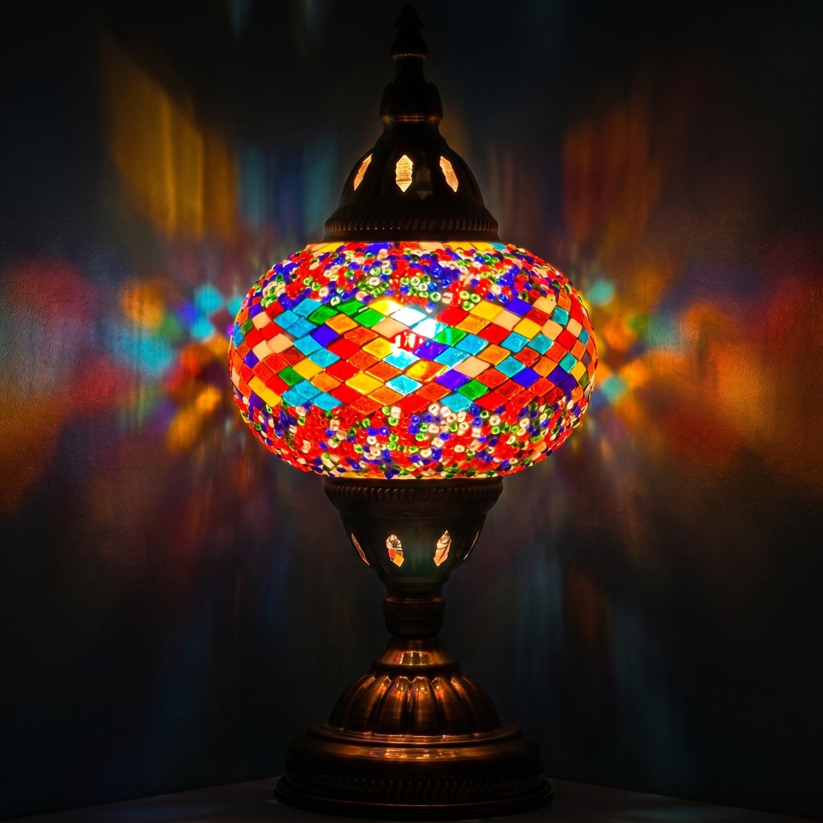 Color Spectrum mosaic glass table lamp — glowing against a deep charcoal background