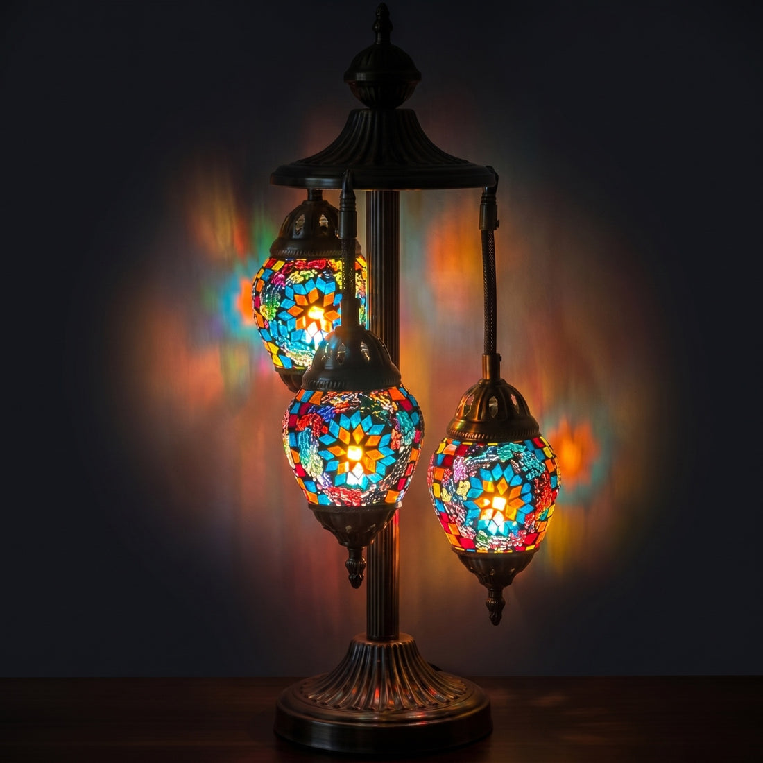 Coral Reef Elegance mosaic glass table lamp — glowing against a deep charcoal background