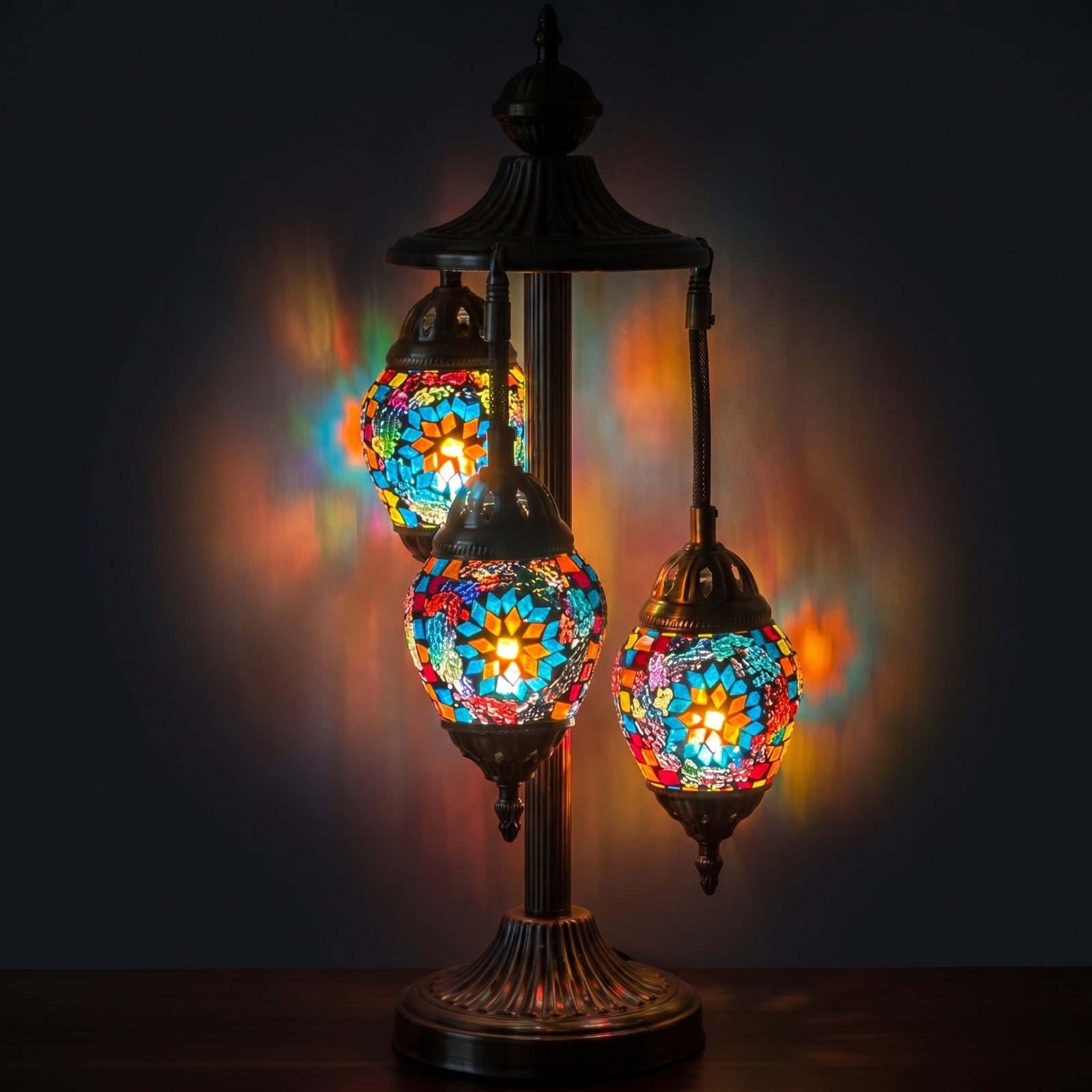 Coral Reef Elegance mosaic glass table lamp — glowing against a deep charcoal background
