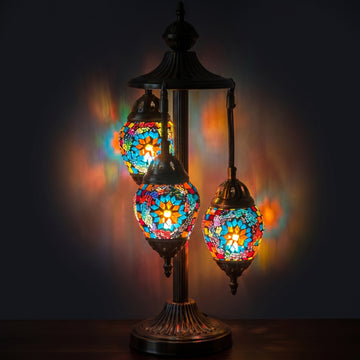 Coral Reef Elegance mosaic glass table lamp — glowing against a deep charcoal background