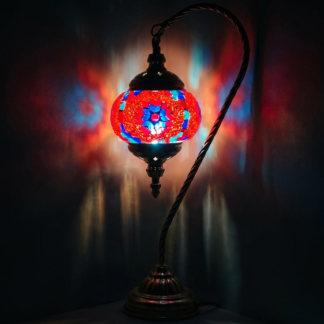 Crimson Bloom mosaic glass table lamp — glowing against a deep charcoal background
