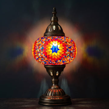 Desert Bloom Mosaic mosaic glass table lamp — glowing against a deep charcoal background