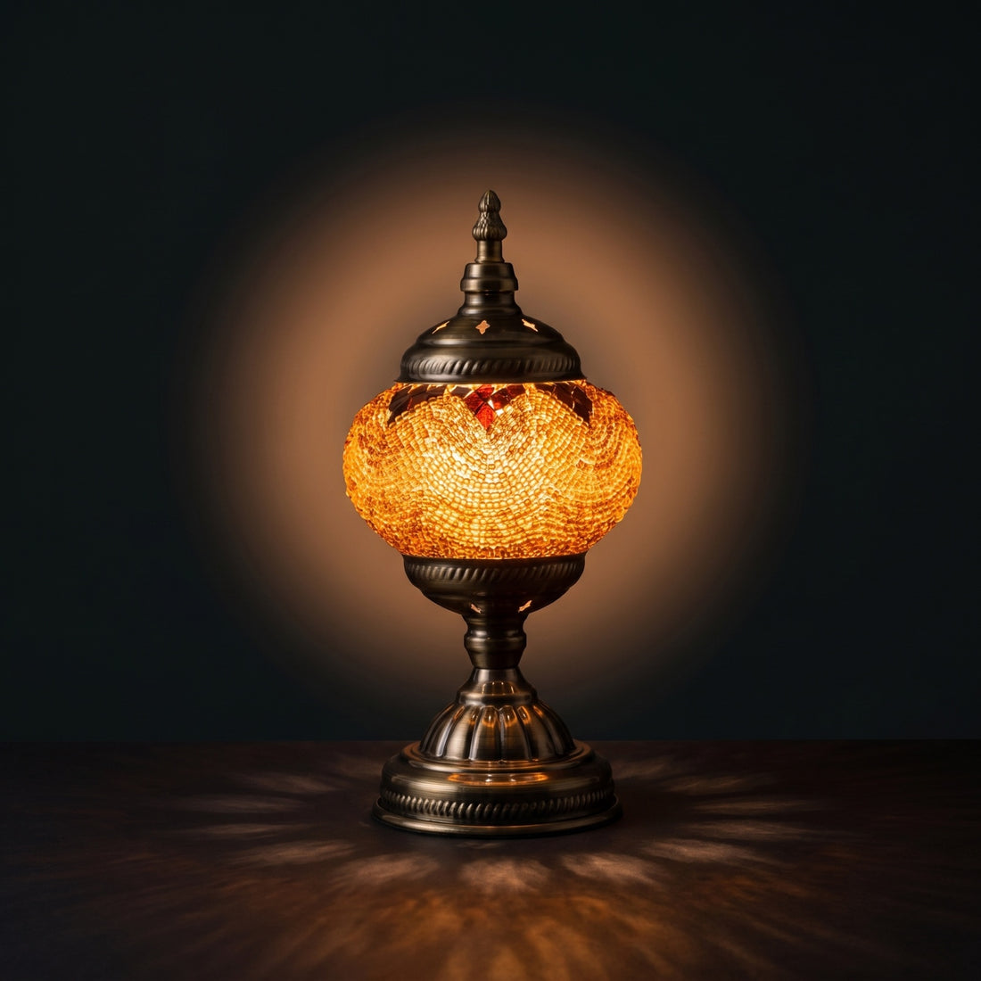 Desert Mirage mosaic glass table lamp — glowing against a deep charcoal background