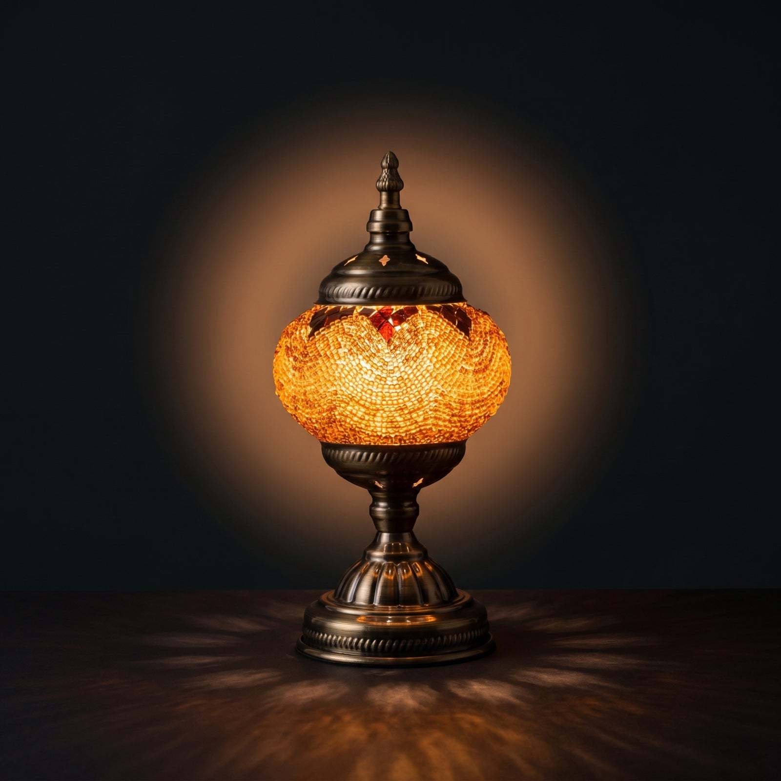 Desert Mirage mosaic glass table lamp — glowing against a deep charcoal background