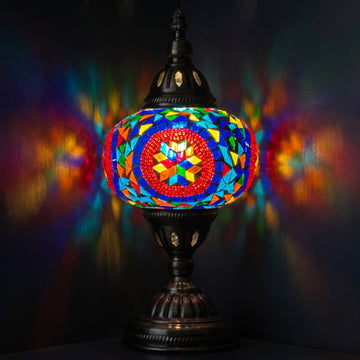 Desert Rose Blue Mosaic Desk Lamp mosaic glass table lamp — glowing against a deep charcoal background