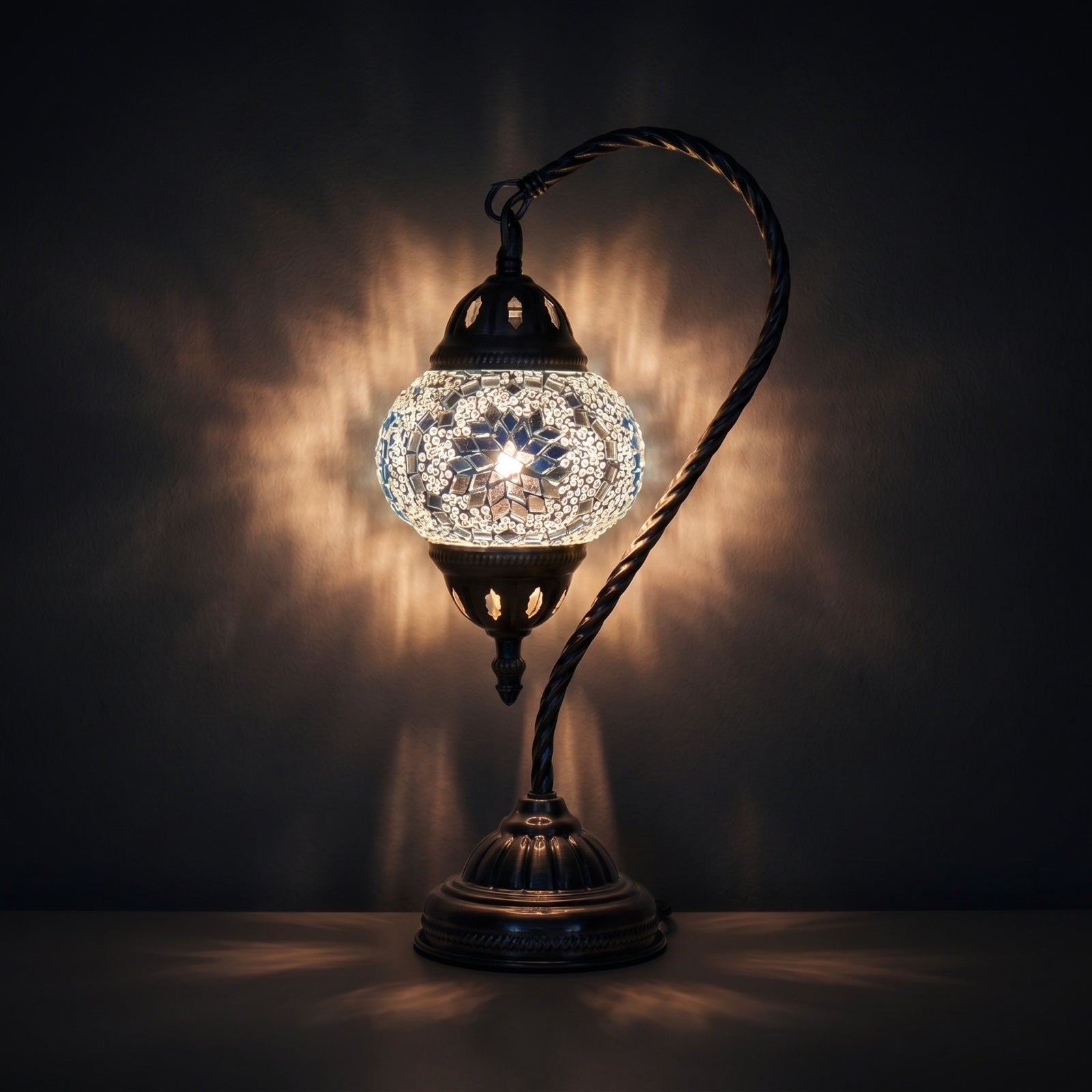 Ethereal Flora mosaic glass table lamp — glowing against a deep charcoal background
