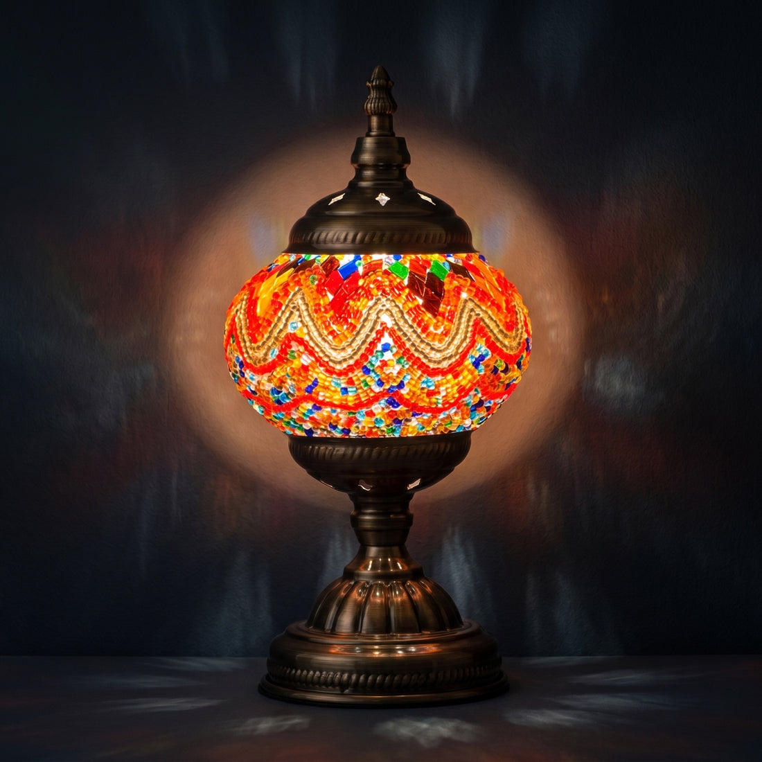 Fiery Echoes mosaic glass table lamp — glowing against a deep charcoal background