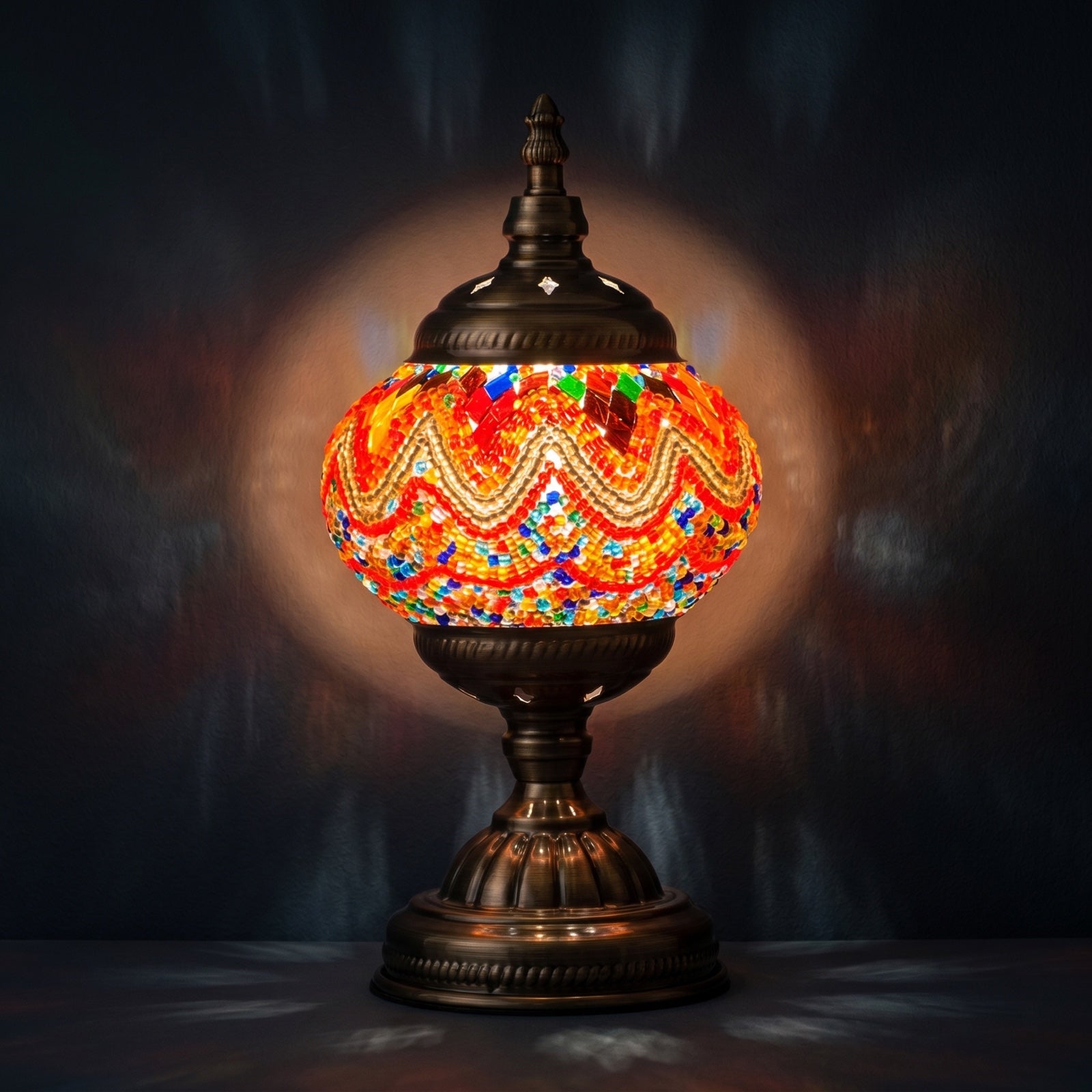 Fiery Echoes mosaic glass table lamp — glowing against a deep charcoal background