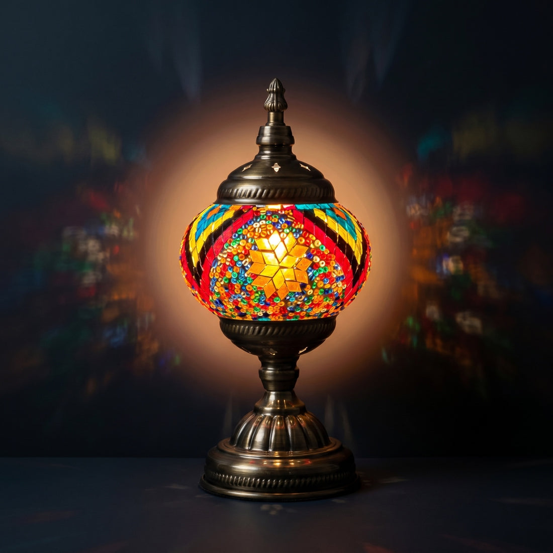 Floral Spectacle mosaic glass table lamp — glowing against a deep charcoal background