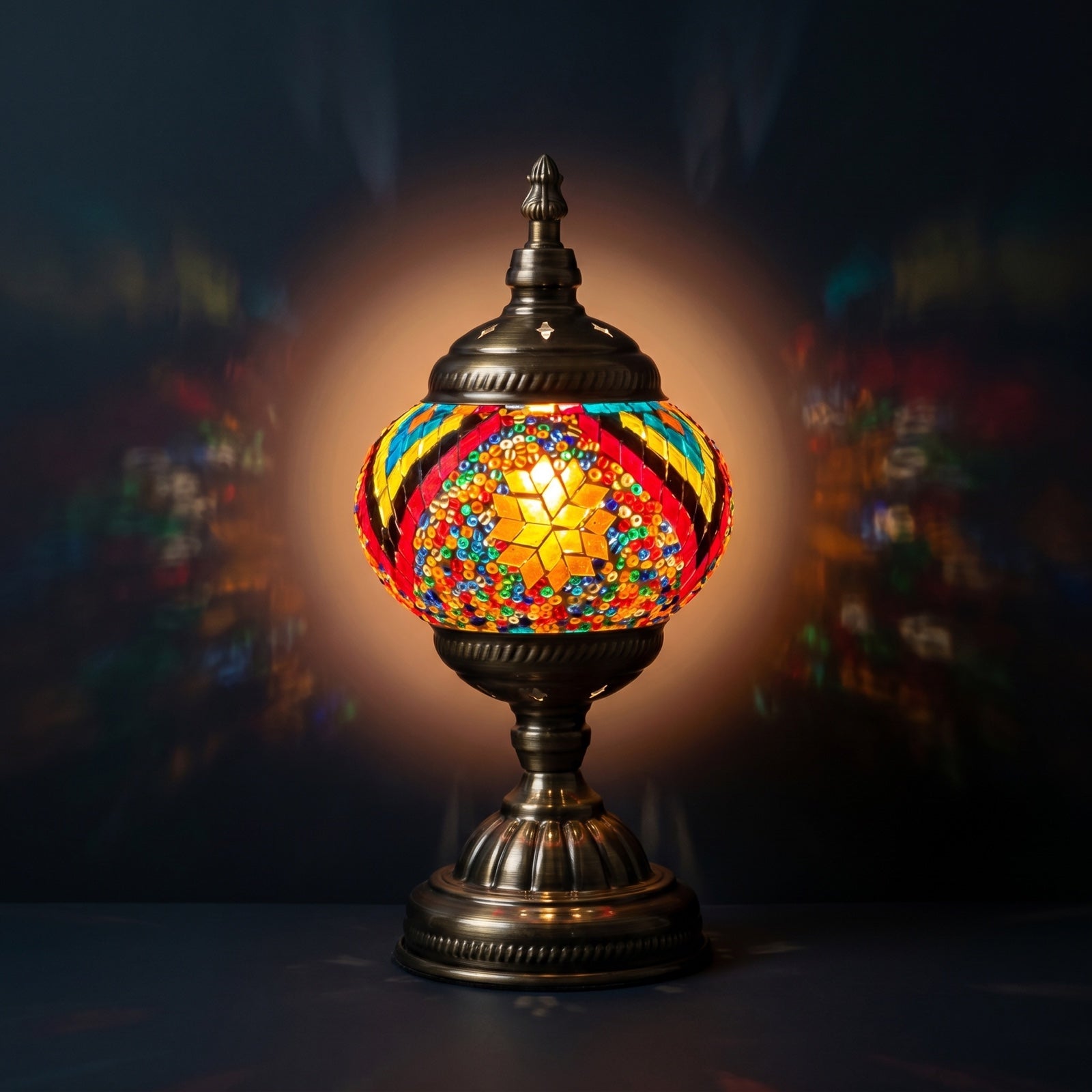 Floral Spectacle mosaic glass table lamp — glowing against a deep charcoal background