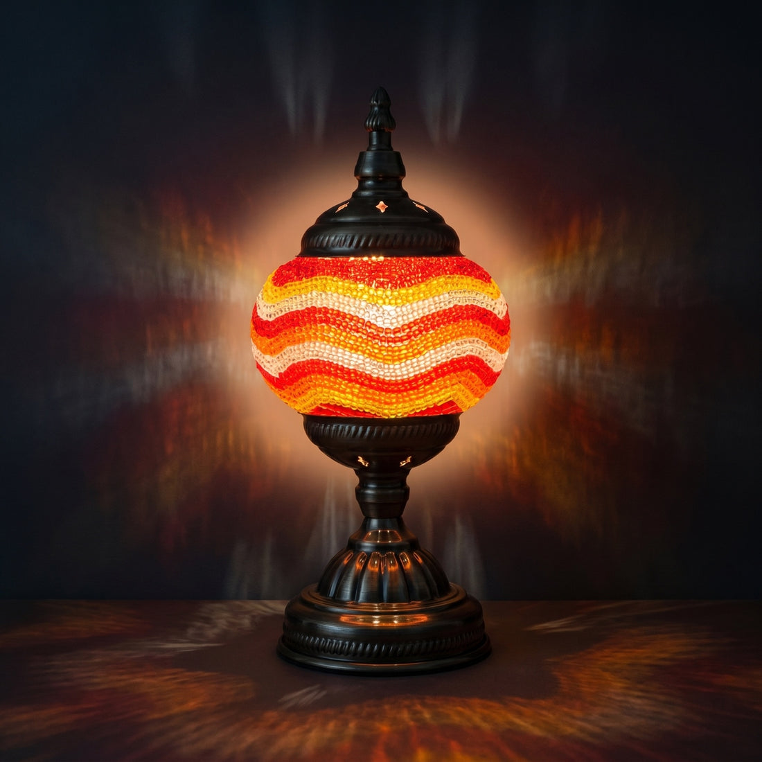 Golden Sands mosaic glass table lamp — glowing against a deep charcoal background