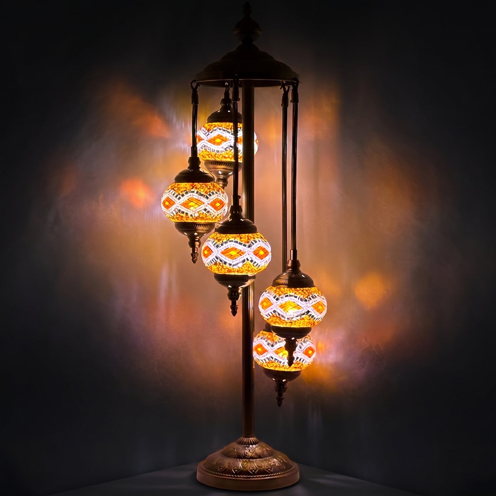 Golden Sparkle mosaic glass table lamp — glowing against a deep charcoal background