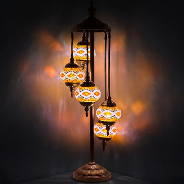 Golden Sparkle mosaic glass table lamp — glowing against a deep charcoal background