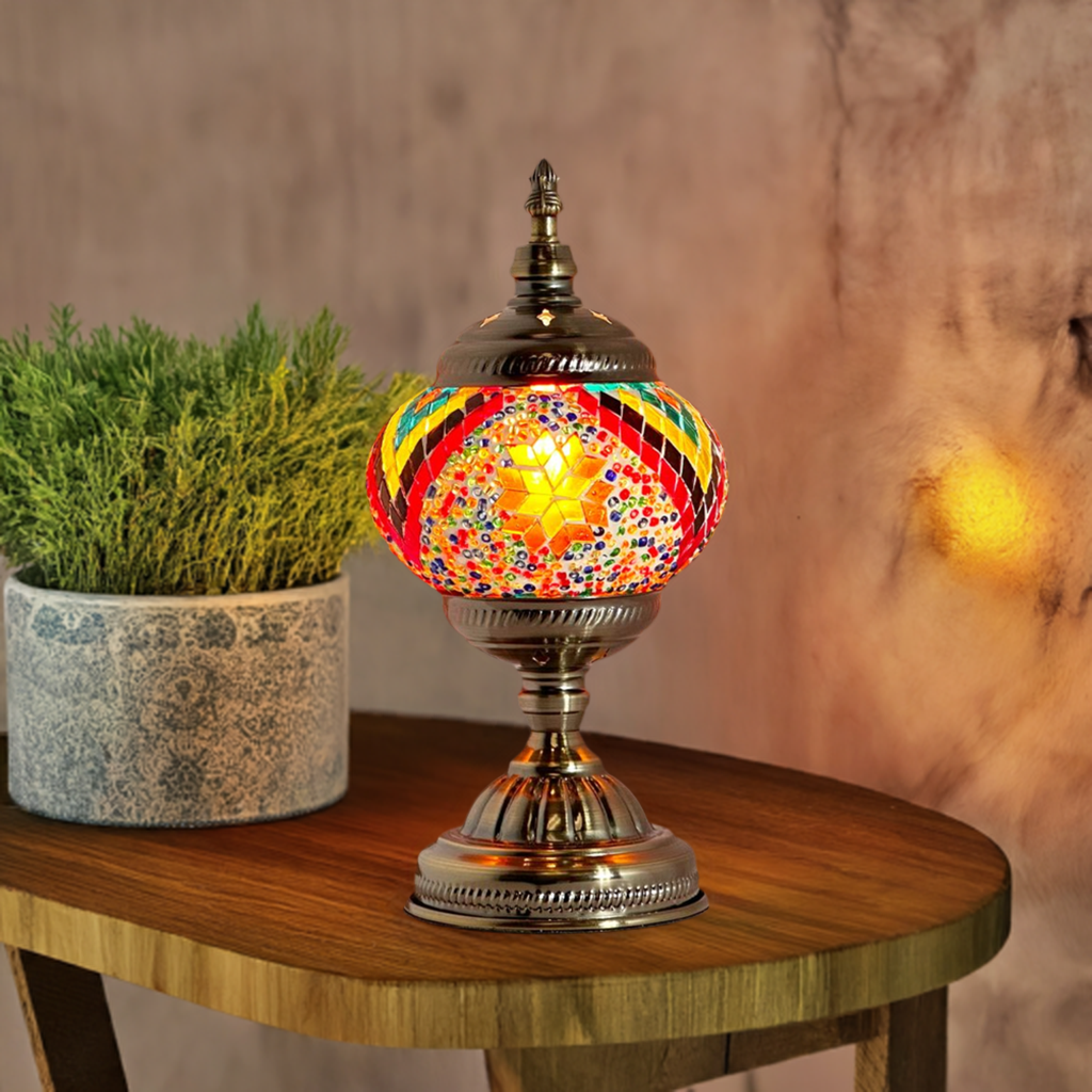 Floral Spectacle mosaic glass table lamp — glowing in a styled room