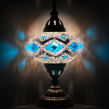 Icy Elegance mosaic glass table lamp — glowing against a deep charcoal background