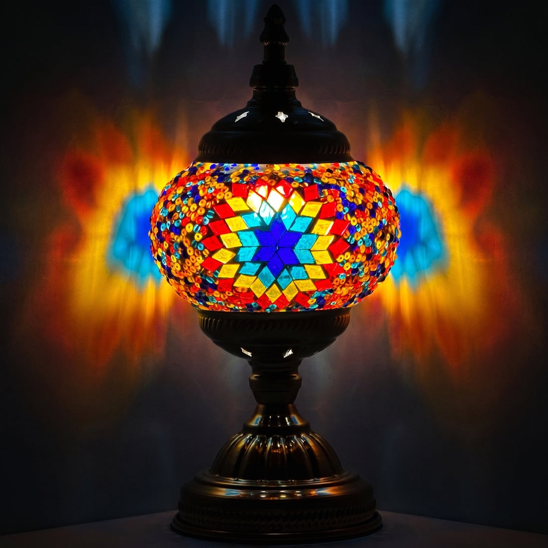 Kaleidoscope Dreams mosaic glass table lamp — glowing against a deep charcoal background