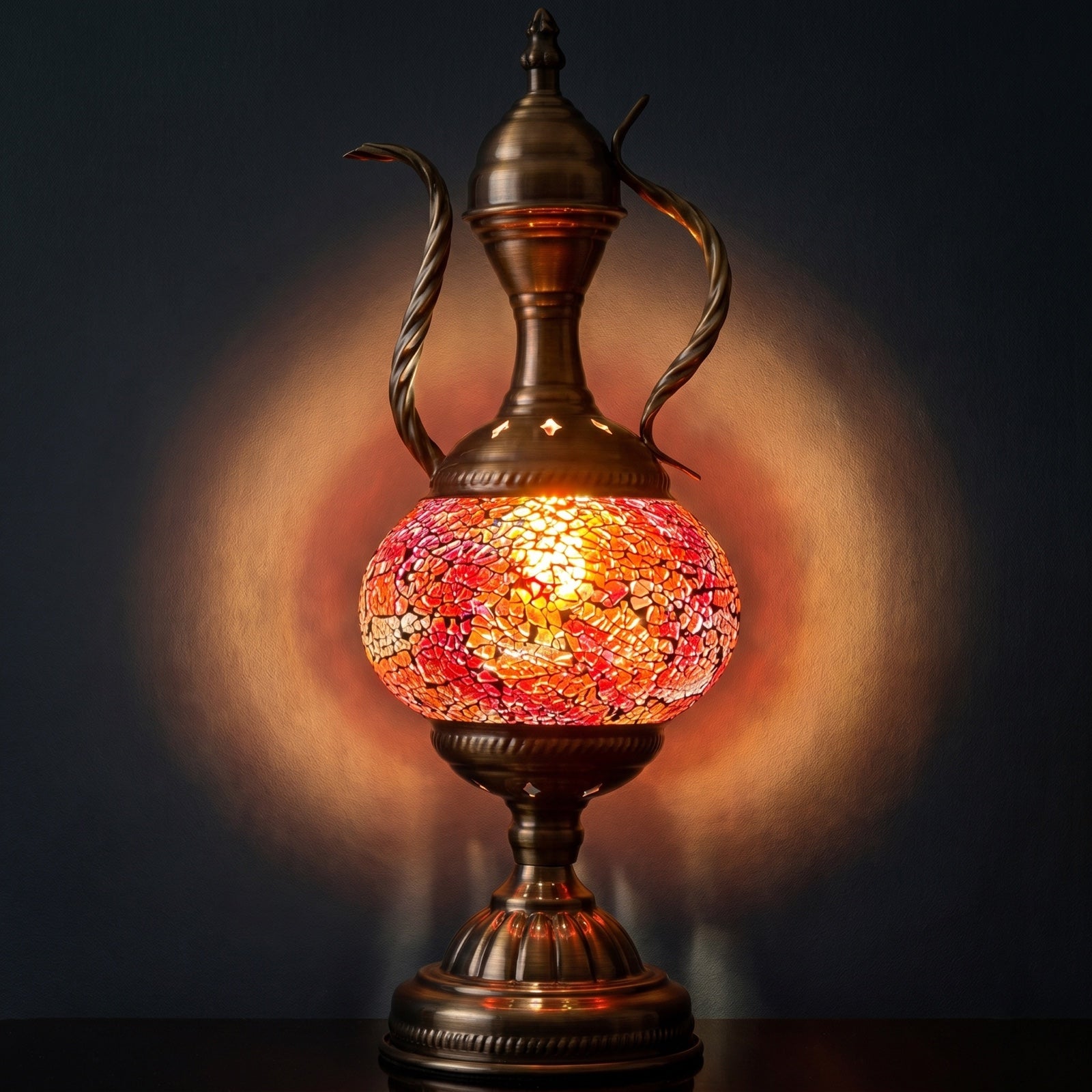 Mediterranean Allure mosaic glass table lamp — glowing against a deep charcoal background