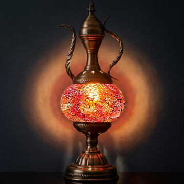 Mediterranean Allure mosaic glass table lamp — glowing against a deep charcoal background